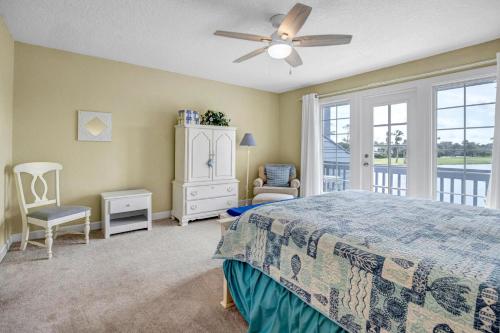 a bedroom with a bed and a ceiling fan at Beachy Vibes in Ponte Vedra Beach