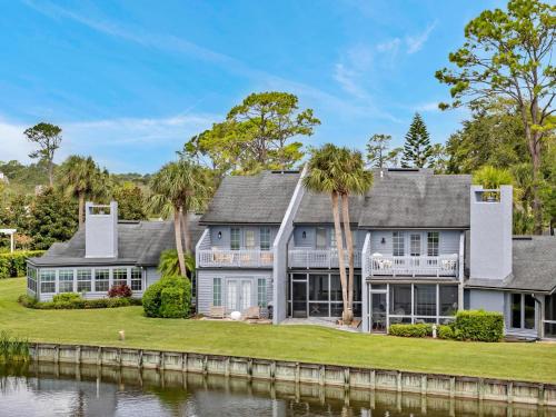 an exterior view of a house with palm trees at Beachy Vibes in Ponte Vedra Beach