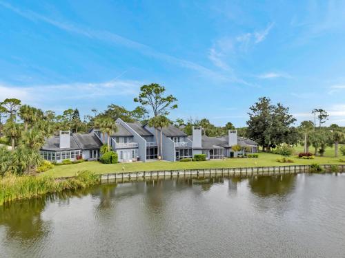 an exterior view of a large house with a body of water at Beachy Vibes in Ponte Vedra Beach