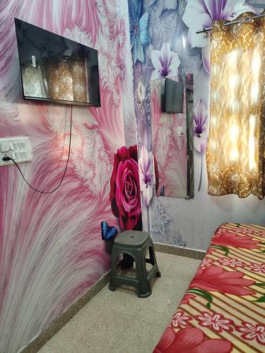 a room with a wall with a flower mural at Shri prabhu dham- Near Prem Mandir in Vrindāvan