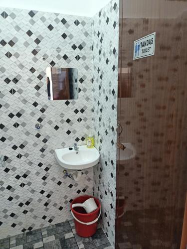 a small bathroom with a sink and a shower at The Pesona Beach House in Bachok
