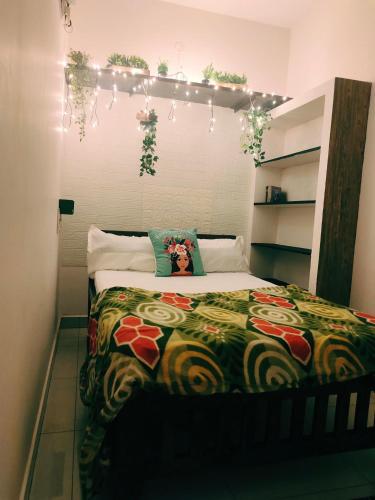 a bedroom with a bed with a colorful blanket at DREAMY cosy stay 4bhk, 6 mins to Whitetown & Beach - COPPER in Puducherry