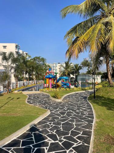 a cobblestone walkway in a park with a playground at Santorini 3BR Resort Apartment Pool & Gym in Negombo