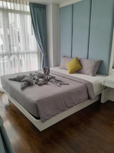 a bedroom with a large bed with a large window at Arisara place in Koh Samui