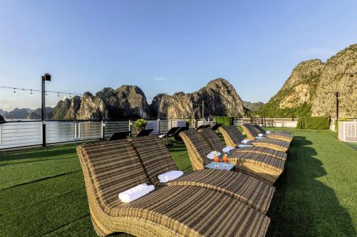 a row of chairs sitting on top of a cruise ship at Verdure Lotus Grandeur Cruise on Ha Long Bay in Ha Long
