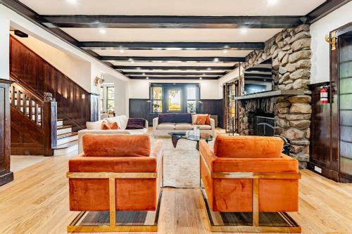 a living room with couches and a stone fireplace at Lakeview-Sleeps 12-King Suites-7BR - Firepit in Monroe