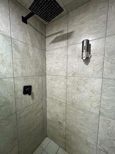 a bathroom with a shower with a glass door at Departamento Junto a la Feria de Pachuca in Pachuca de Soto