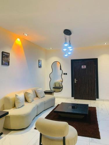 a living room with a couch and a coffee table at Alphavista Luxury Apartments in Port Harcourt