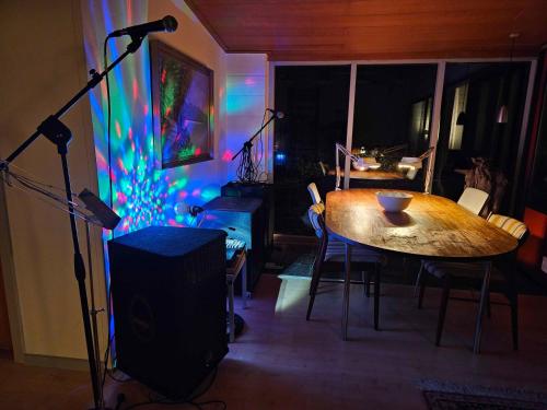 a room with a table and a stage with a microphone at Welcome To The Multihouse In The Countryside in Nakskov
