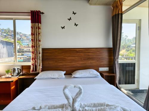 a bedroom with a bed with a heart on it at CARMEL HOME STAY in Munnar