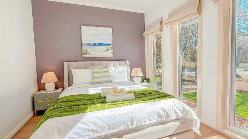 a bedroom with a large bed and a window at StayAU Family Haven Pet-Friendly Caroline Springs in Caroline Springs