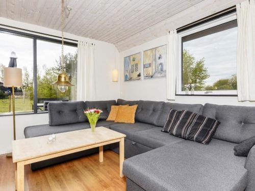 a living room with a couch and a table at 6 person holiday home in Nibe in Nibe