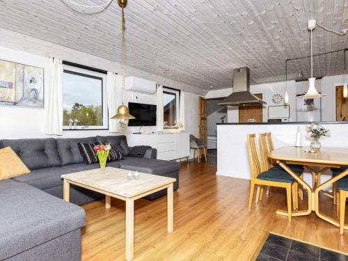 a living room with a couch and a table at 6 person holiday home in Nibe in Nibe
