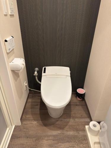 a bathroom with a white toilet in a stall at CONDOMINIUM HOTEL Riyuka in KADENA 1 in Kadena