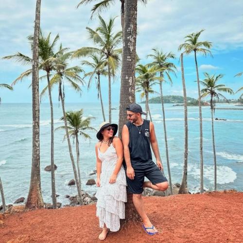 a man and a woman standing on the beach at Amible Guest Home in Mirissa