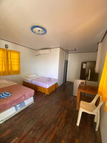 a room with two beds and a table and a desk at Paradise Bungalows Lamai Beach in Lamai