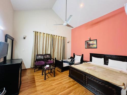 a bedroom with a bed and a couch and a tv at Holiday Inn islamabad in Islamabad