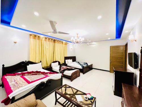 a living room with two beds and a couch at Holiday Inn islamabad in Islamabad