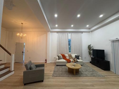 a living room with a couch and a table at Luxury Apartments in Georgetown