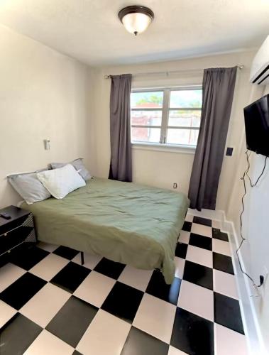 a bedroom with a bed and a checkered floor at Central Tampa Hot Spot! in Tampa