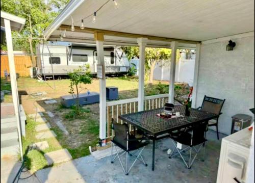 a screened in porch with a table and chairs at Central Tampa Hot Spot! in Tampa