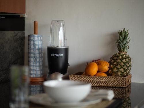 a table with a blender and a bowl of fruit at Private Pool, Rice Fields, 2 BR Villa Near Canggu in Badung