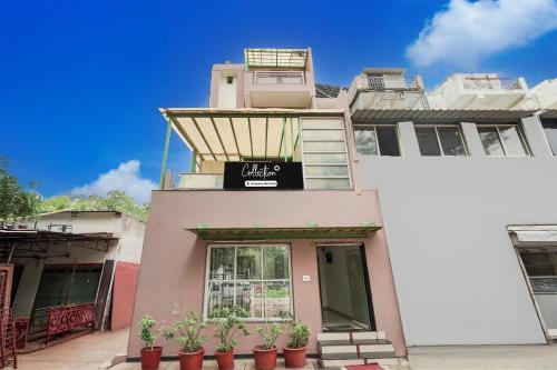 a building with a sign on the front of it at Super Collection O Sachivalaya Metro Station Gandhinagar Formerly Hotel Ghunghat Inn in Gandhinagar