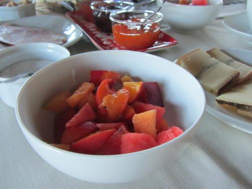 a bowl of fruit on a table with other foods at Le relais des deux tours in Brémondans