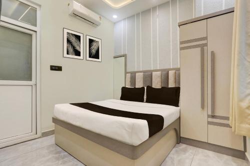a bedroom with a bed in a room at Super Hotel O Maharshi Valmiki International Airport Formerly Gaurav Inn in Faizābād