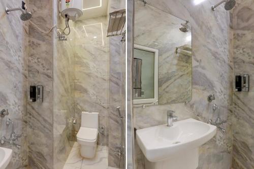 a bathroom with a sink and a toilet and a shower at Super Hotel O Maharshi Valmiki International Airport Formerly Gaurav Inn in Faizābād