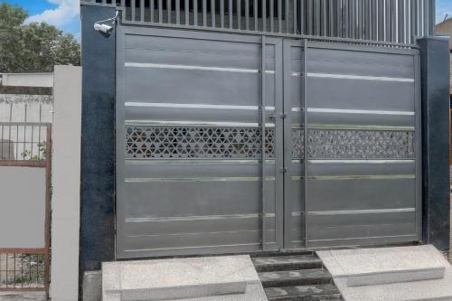 a large metal garage door on a building at Super Hotel O Maharshi Valmiki International Airport Formerly Gaurav Inn in Faizābād