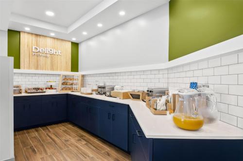 a kitchen with a counter with a jug of orange juice at Spark By Hilton Traverse City in Traverse City