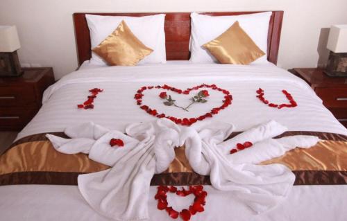 a bed with white towels and hearts on it at Natha Ubud Private Pool Villa by EPS in Ubud
