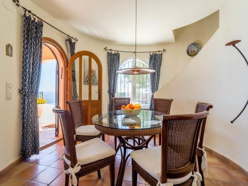 a dining room with a table and chairs at Villa with Sea Breeze Charm in Cumbre del Sol