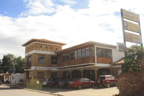a building with cars parked in front of it at La Foguera Sutamarchán in Sutamarchán