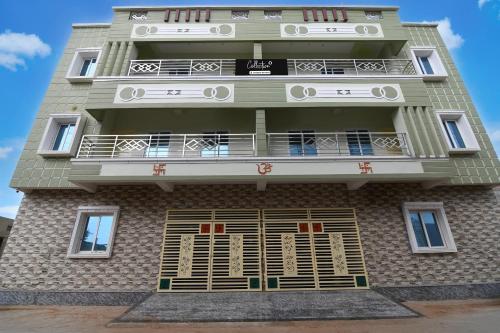 a tall building with a balcony on top of it at Collection O Shree Jagannatha Temple Puri Formerly Nirmalya Residency in Puri