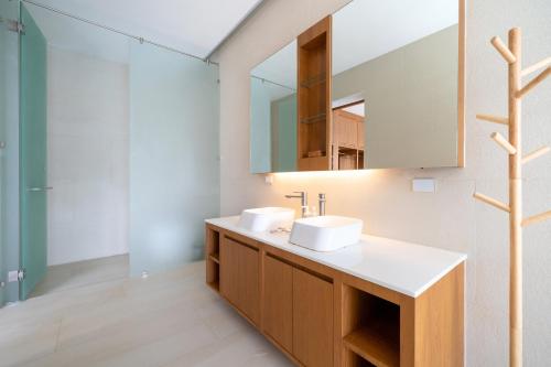 a bathroom with two sinks and a mirror at The Trinity C4 new modern 5BR villa with 20M Pool in Ban Pak Lak