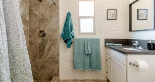 a bathroom with a shower and a sink at Central House with Pool & Hot Tub in Tucson