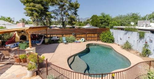 a backyard with a swimming pool and a patio at Central House with Pool & Hot Tub in Tucson