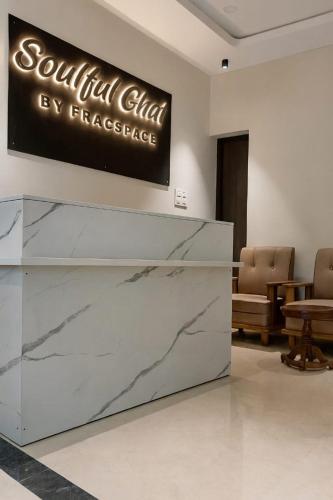 a lobby with a reception desk and a sign at Soulful Ghat By Fracspace in Varanasi