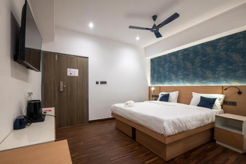 a bedroom with a bed and a flat screen tv at Soulful Ghat By Fracspace in Varanasi