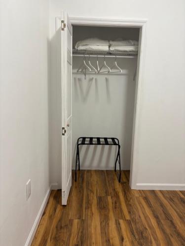 a closet with a door open with a shelf at Luxury Apartments in Georgetown