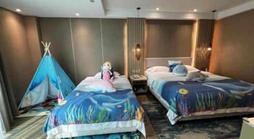 a bedroom with two beds and a tent at Excemon Beach Hotel Beihai in Beihai