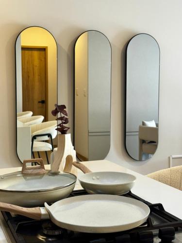 a bathroom with two sinks and mirrors on a counter at Loft Americana Chapultepec Alberca Wifi AC in Guadalajara