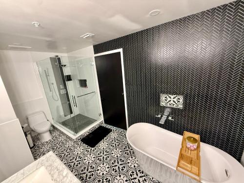 La salle de bains est pourvue d'une baignoire, d'une douche et de toilettes. dans l'établissement Channelside Luxury Retreat Spacious 2BR 2BA Condo with Pool, Balcony, Sauna & Gym, à Tampa