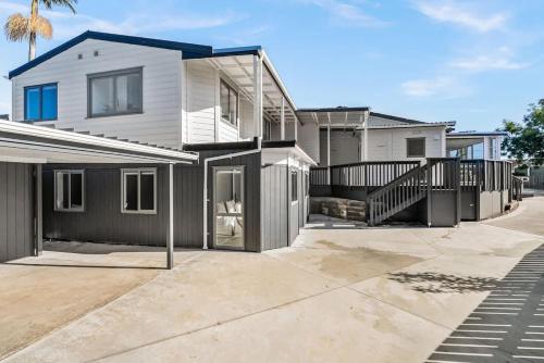 a large white house with a driveway at Deluxe Twin Room at Wolfe Street in Whangarei