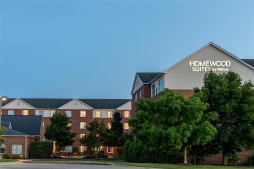 a building with a flowerwood sunrise village sign on it at Homewood Suites by Hilton Detroit-Troy in Birmingham