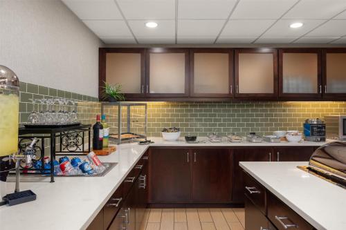 a kitchen with wooden cabinets and white counter tops at Homewood Suites by Hilton Columbus/Polaris in Columbus