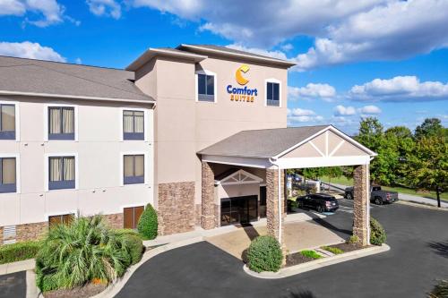 a front view of a hotel with a car parking lot at Comfort Suites Augusta Riverwatch in Augusta