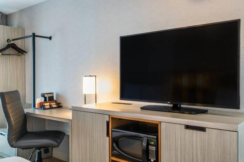 a flat screen tv sitting on top of a entertainment center at Comfort Inn Airport East in Quebec City